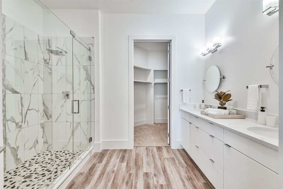 Bathroom, Dual Sink Vanities, Glass Shower, Interior, Marble Walls, Walk-in Closets, Wood Texture Flooring
