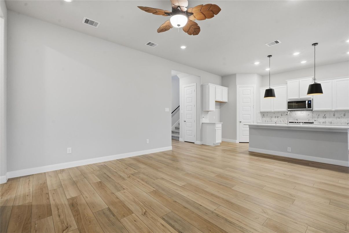 Empty room, Interior, Kitchen, Pendant Lights, Recessed Lighting, Stainless Steel Appliances, Wood Texture Flooring
