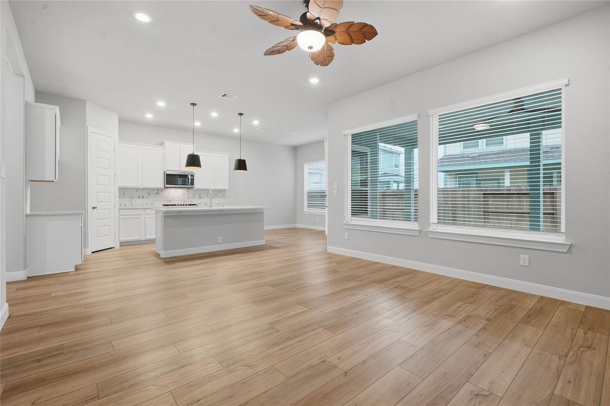 Empty room, Interior, Kitchen, Pendant Lights, Recessed Lighting, Stainless Steel Appliances, Wood Texture Flooring