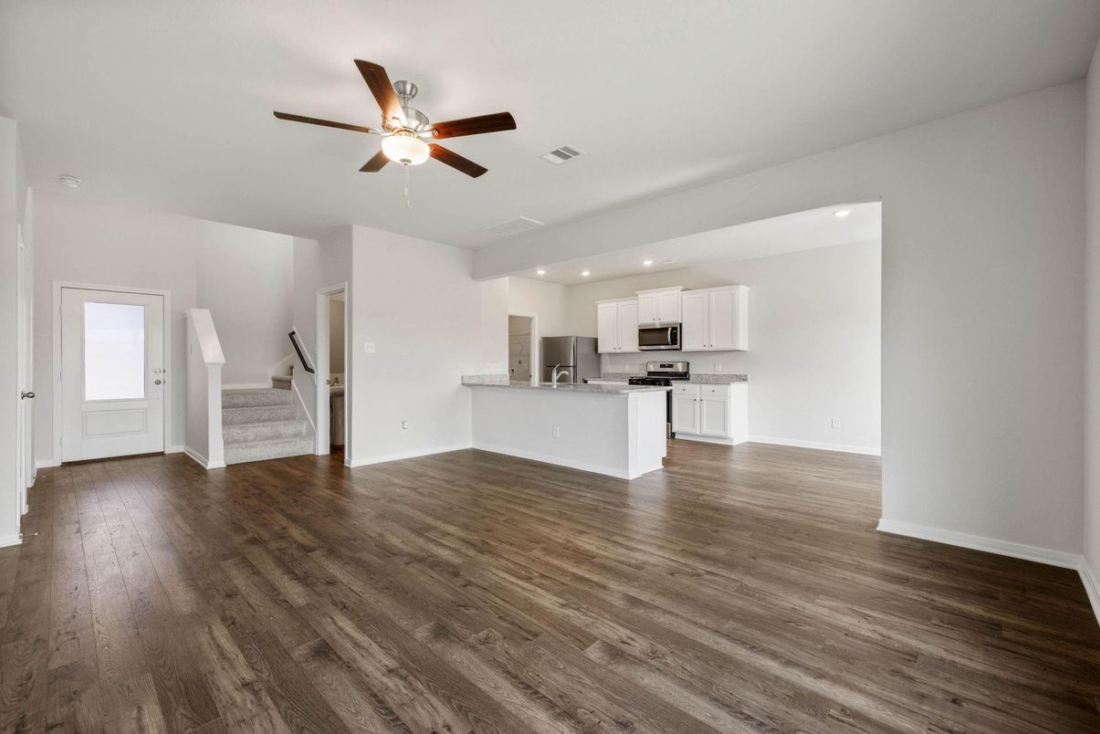 Empty room, Interior, Kitchen, Recessed Lighting, Stainless Steel Appliances, Wood Texture Flooring
