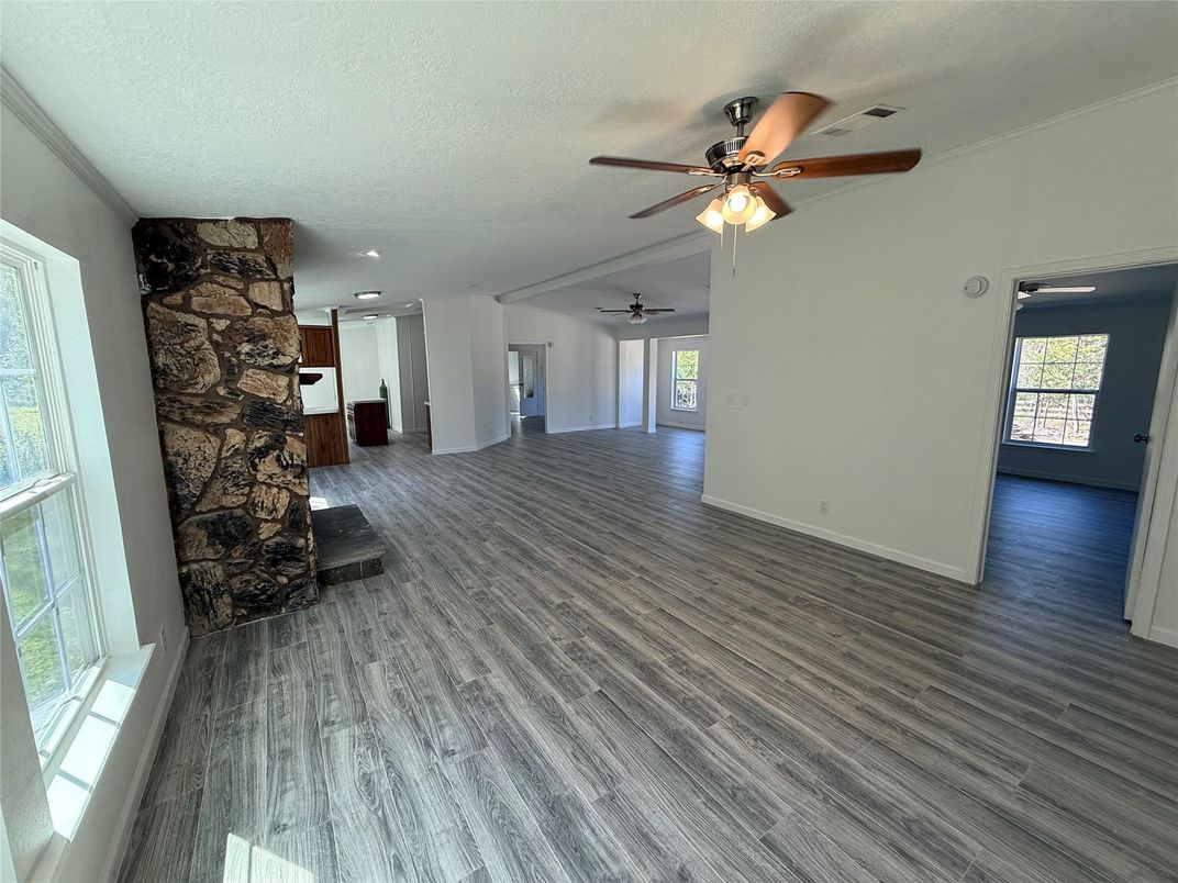 Empty room, Fireplace, Interior, Recessed Lighting, Stone Walls, Wood Texture Flooring