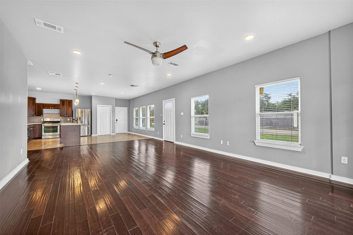 Empty room, Interior, Kitchen, Recessed Lighting, Stainless Steel Appliances, Wood Texture Flooring