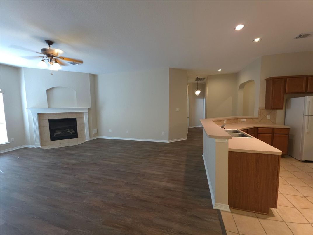 Empty room, Fireplace, Interior, Kitchen, Recessed Lighting, Wood Texture Flooring