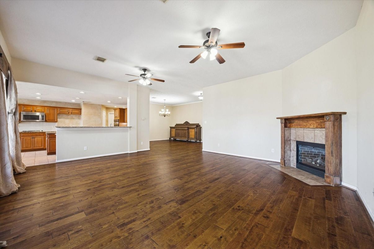 Chandelier, Empty room, Fireplace, Interior, Kitchen, Recessed Lighting, Wood Texture Flooring