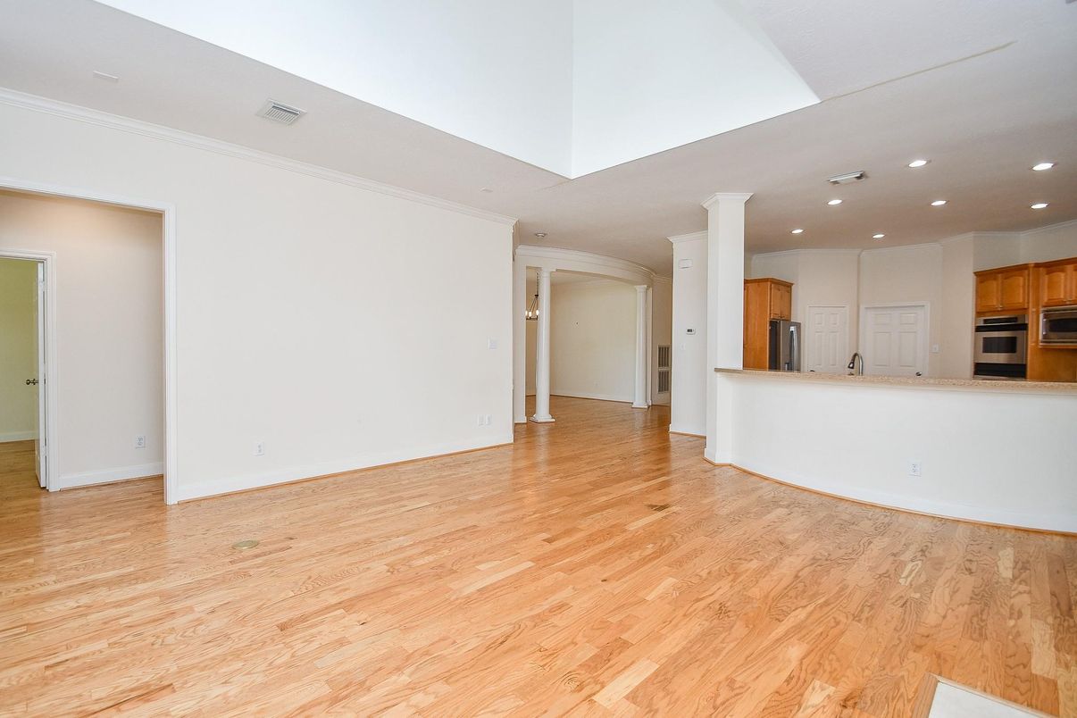 Empty room, Interior, Kitchen, Recessed Lighting, Stainless Steel Appliances, Wood Texture Flooring