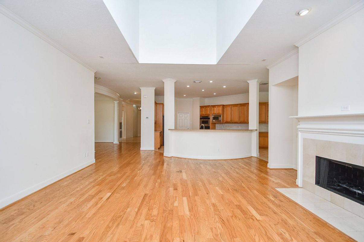 Empty room, Fireplace, Interior, Kitchen, Recessed Lighting, Wood Texture Flooring