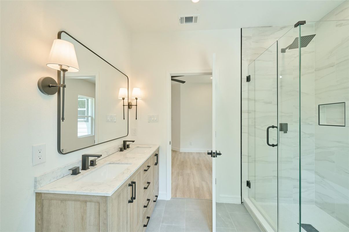 Bathroom, Dual Sink Vanities, Glass Shower, Interior, Marble Walls, Wood Texture Flooring