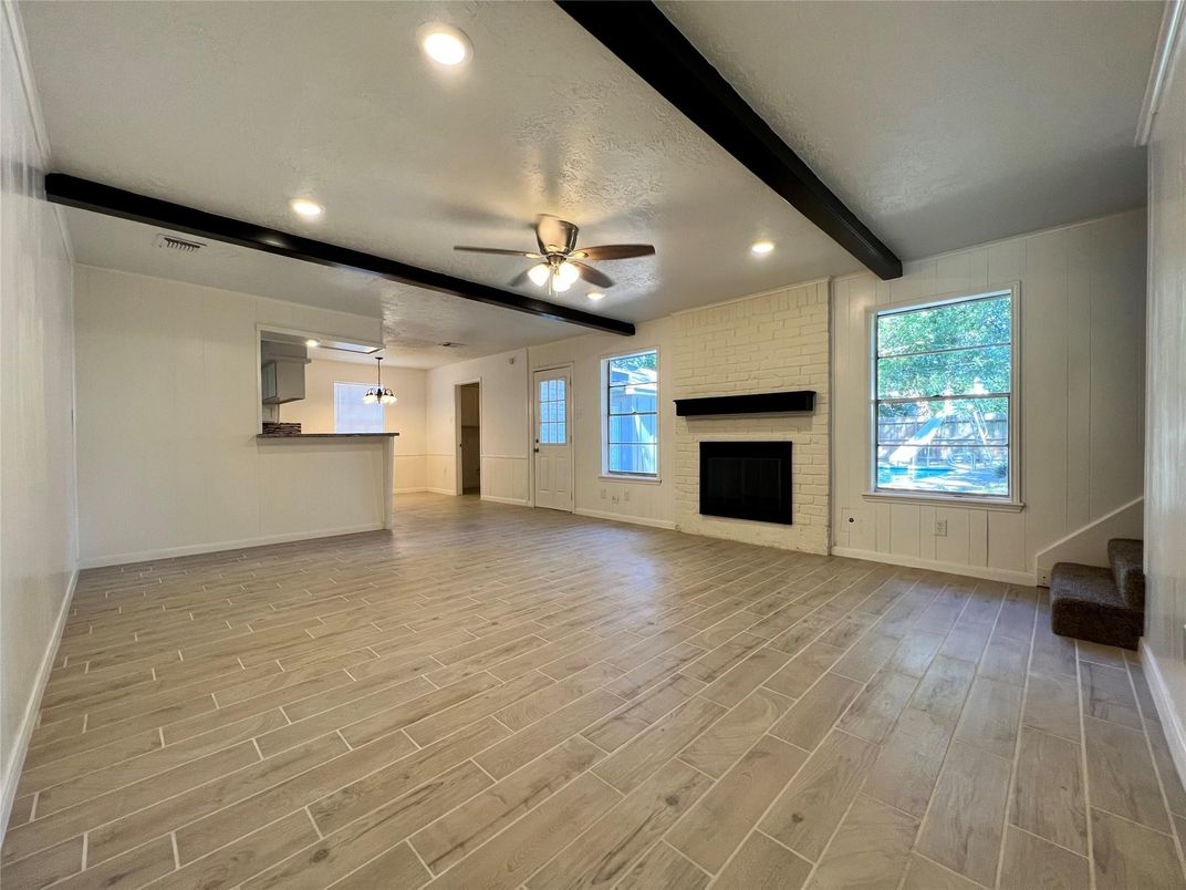 Empty room, Fireplace, Interior, Recessed Lighting, Stone Walls, Wood Texture Flooring