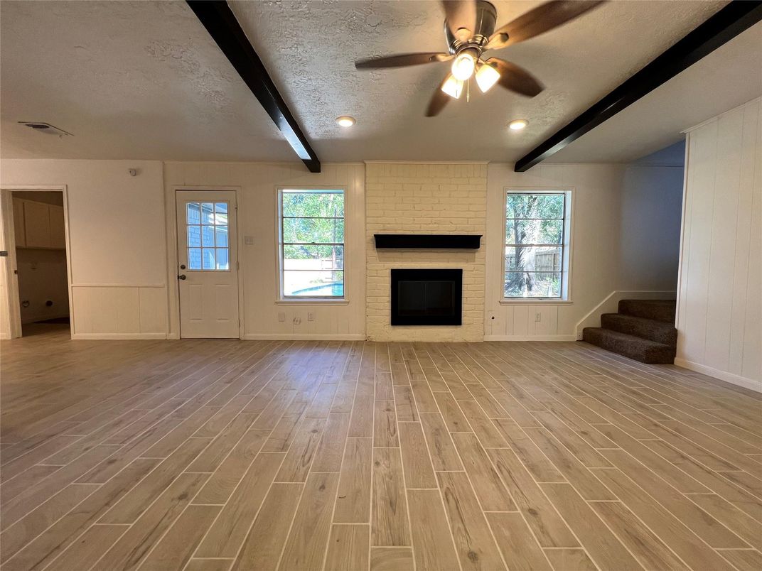 Empty room, Fireplace, Interior, Recessed Lighting, Stone Walls, Wood Texture Flooring
