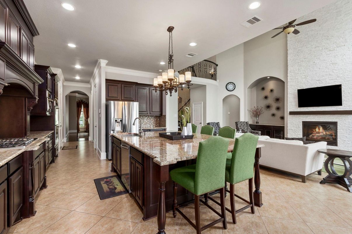 Chandelier, Fireplace, Interior, Kitchen, Living room, Pendant Lights, Recessed Lighting, Stainless Steel Appliances, Stone Walls