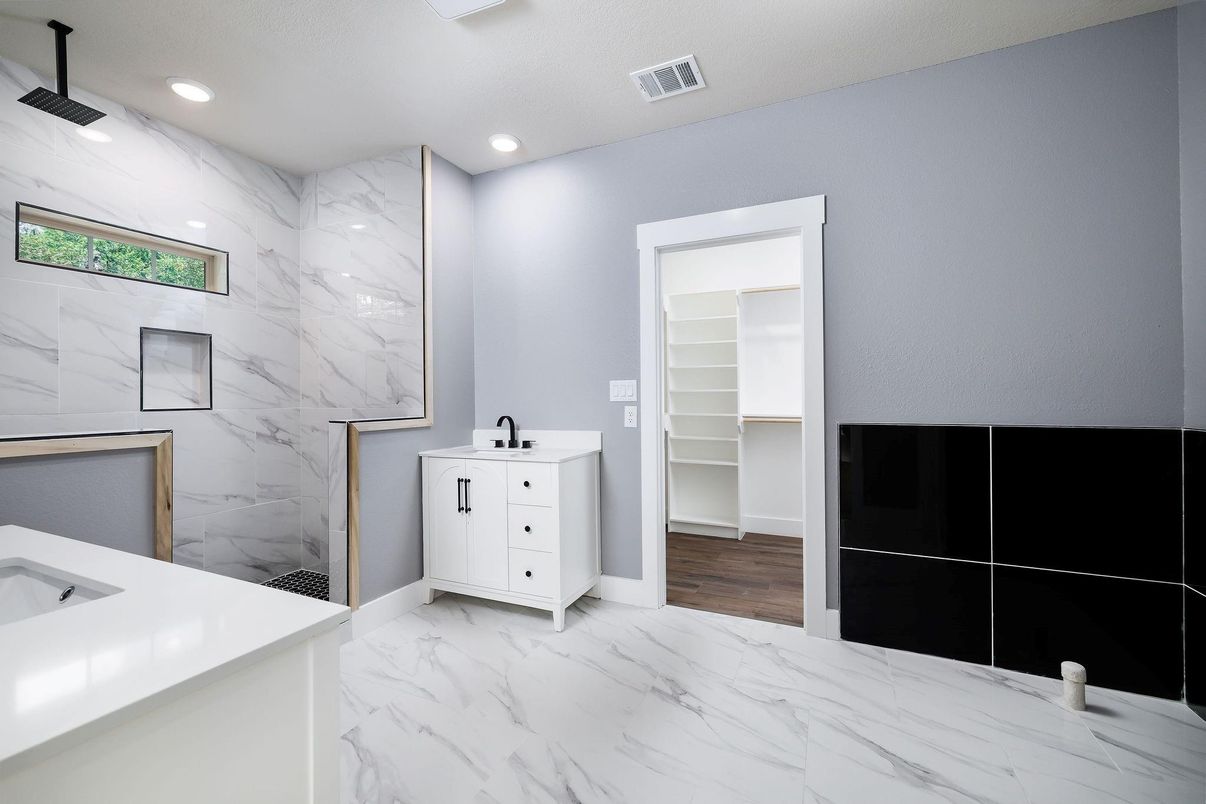 Bathroom, Dual Sink Vanities, Interior, Marble, Marble Walls, Recessed Lighting, Wood Texture Flooring