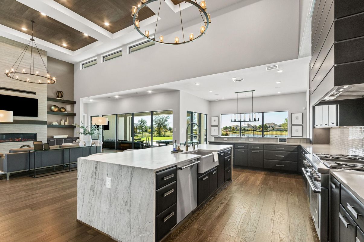 Chandelier, Fireplace, Interior, Kitchen, Living room, Pendant Lights, Recessed Lighting, Stainless Steel Appliances, Wood Texture Flooring