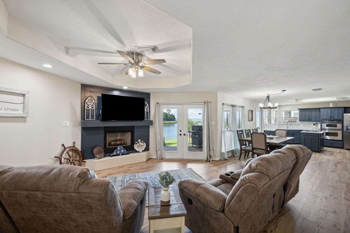 Chandelier, Dining room, Fireplace, Interior, Kitchen, Living room, Recessed Lighting, Stainless Steel Appliances, Wood Texture Flooring