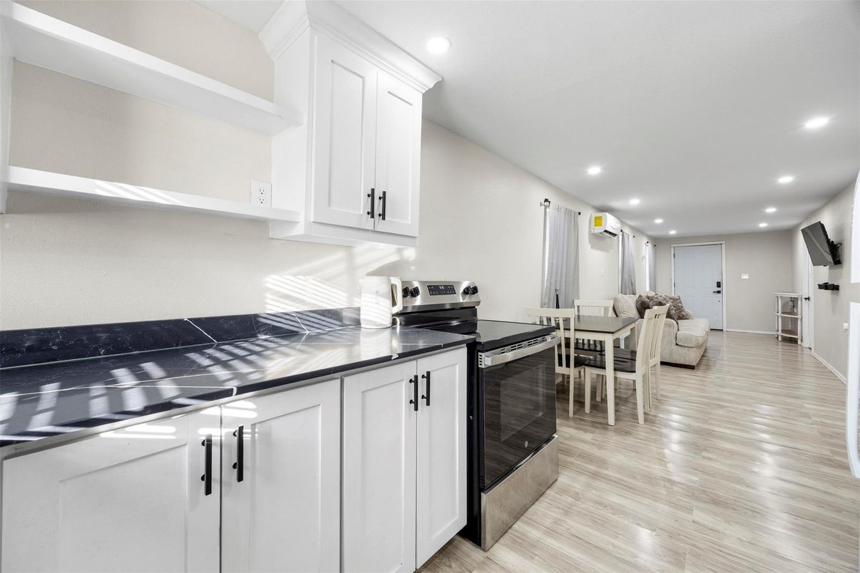 Dining room, Interior, Kitchen, Living room, Recessed Lighting, Stainless Steel Appliances, Wood Texture Flooring