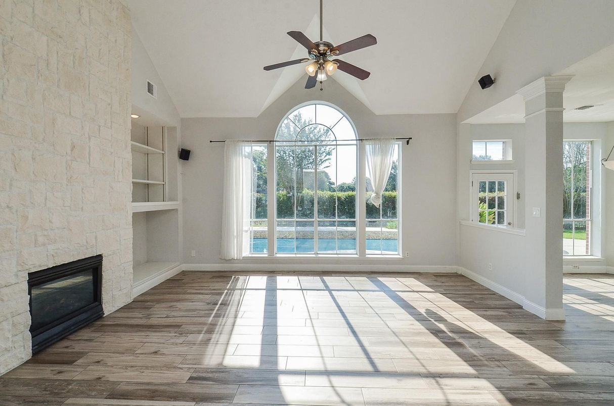 Empty room, Fireplace, Interior, Recessed Lighting, Stone Walls, Wood Texture Flooring
