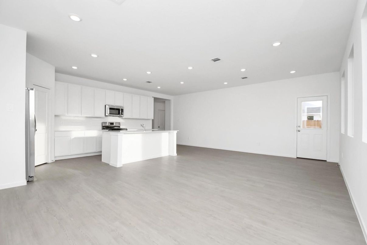 Empty room, Interior, Kitchen, Recessed Lighting, Stainless Steel Appliances, Wood Texture Flooring