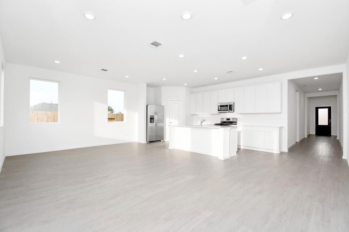 Empty room, Interior, Kitchen, Recessed Lighting, Stainless Steel Appliances, Wood Texture Flooring