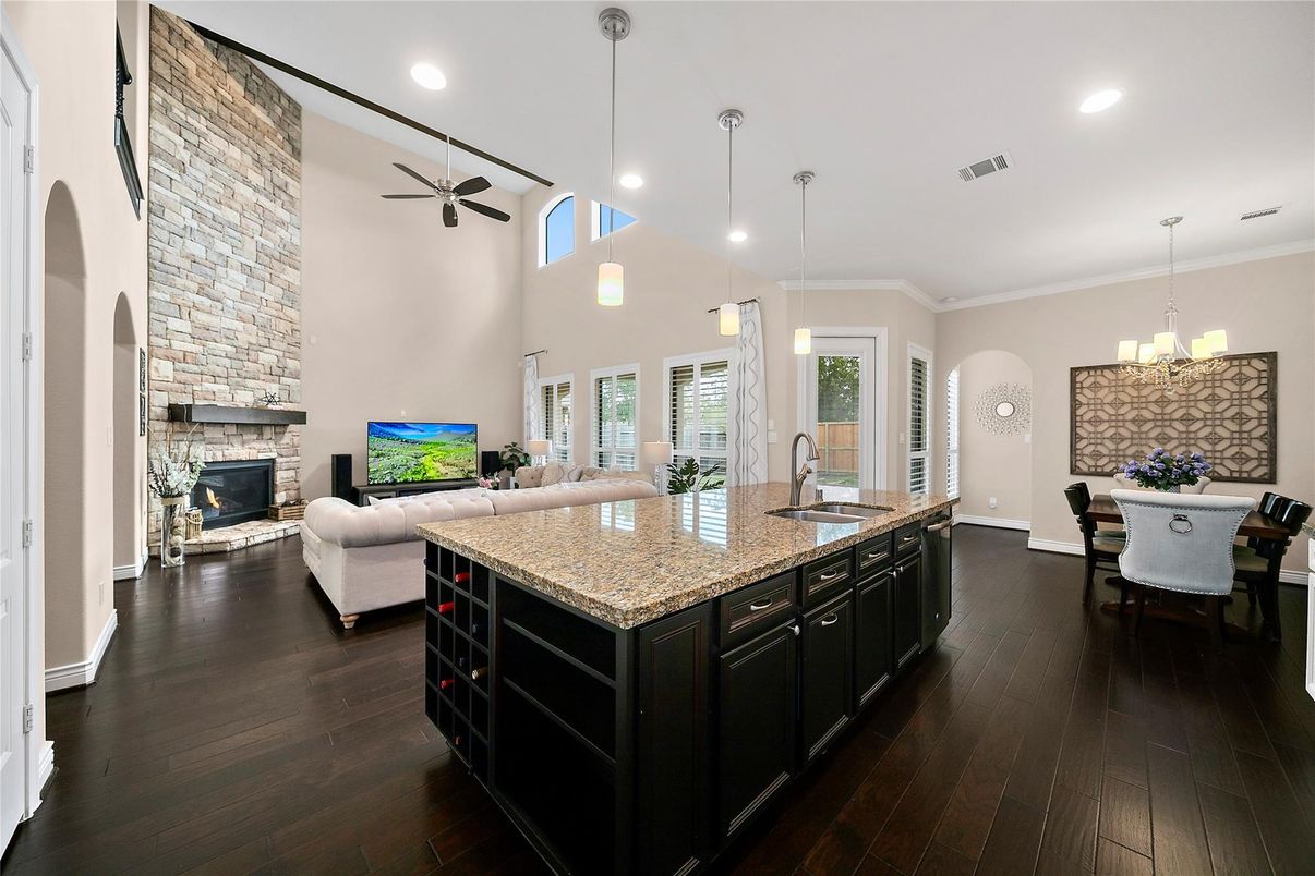 Chandelier, Dining room, Fireplace, Interior, Living room, Pendant Lights, Recessed Lighting, Wood Texture Flooring