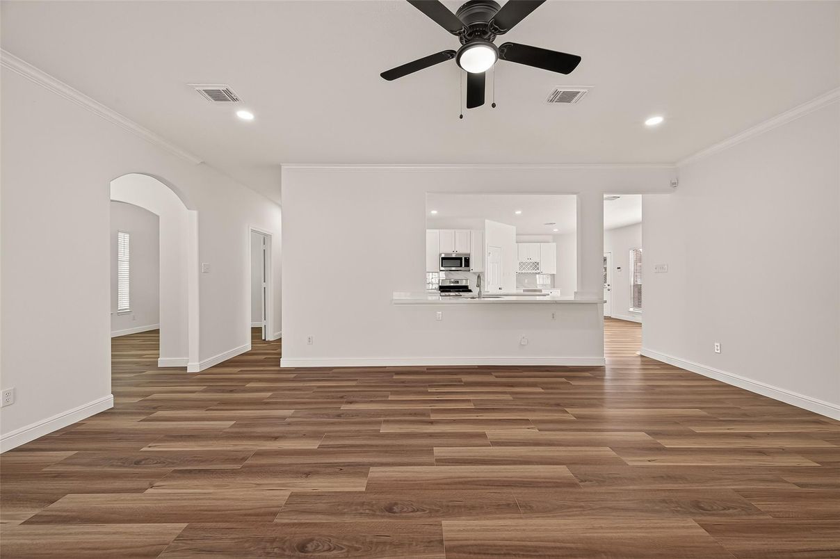 Empty room, Interior, Kitchen, Recessed Lighting, Stainless Steel Appliances, Wood Texture Flooring
