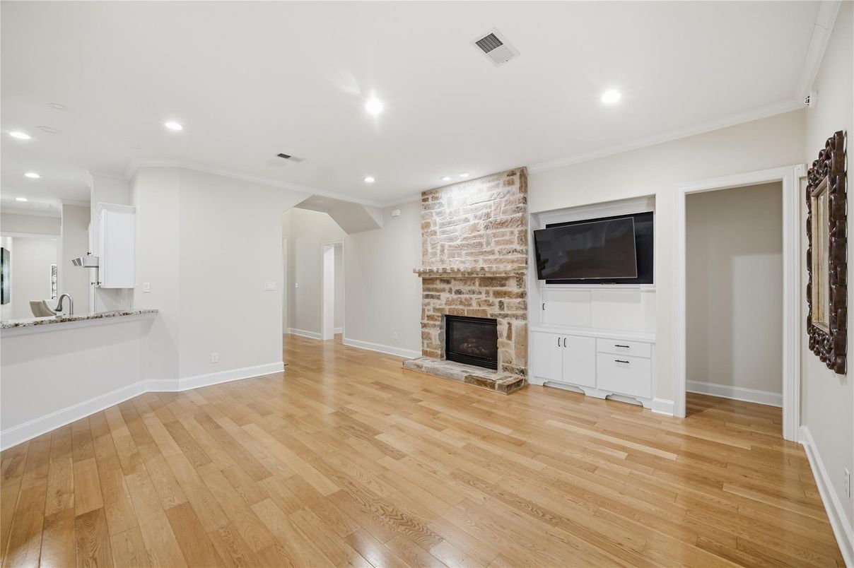 Empty room, Fireplace, Interior, Recessed Lighting, Stone Walls, Wood Texture Flooring