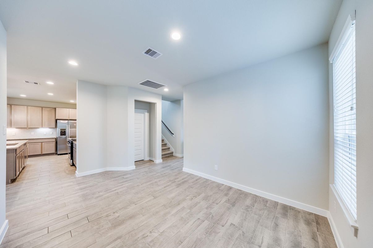 Empty room, Interior, Kitchen, Recessed Lighting, Stainless Steel Appliances, Wood Texture Flooring