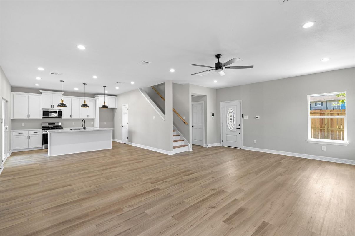 Empty room, Interior, Kitchen, Pendant Lights, Recessed Lighting, Stainless Steel Appliances, Wood Texture Flooring
