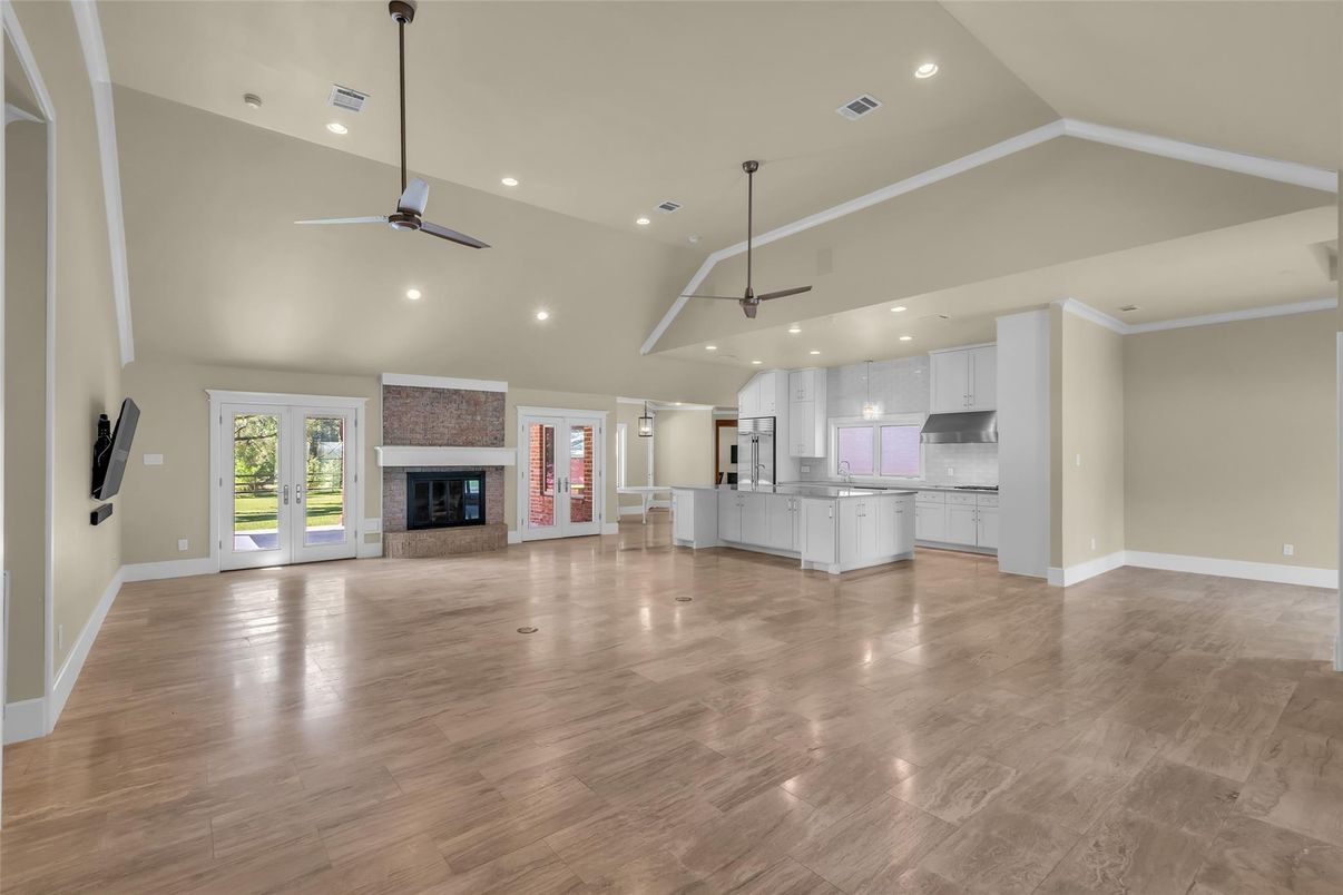 Empty room, Fireplace, Interior, Kitchen, Pendant Lights, Recessed Lighting, Wood Texture Flooring