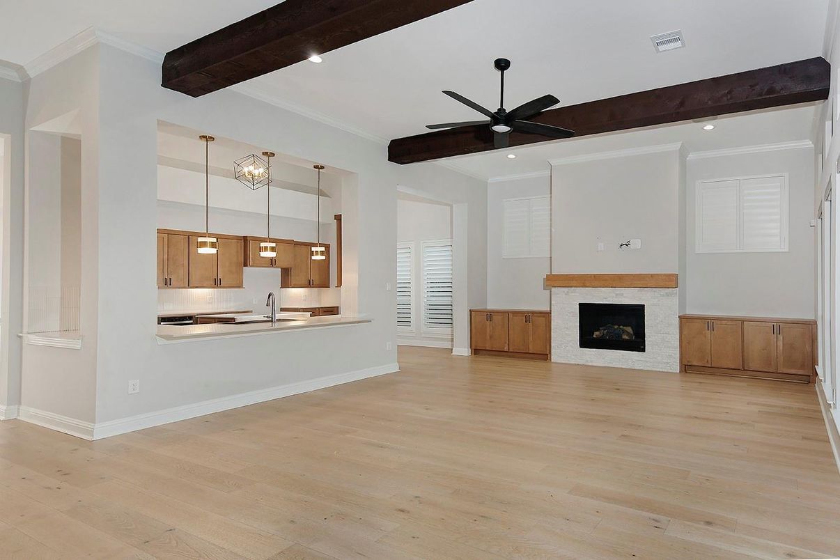 Empty room, Fireplace, Interior, Kitchen, Pendant Lights, Recessed Lighting, Stainless Steel Appliances, Wooden Beams, Wood Texture Flooring