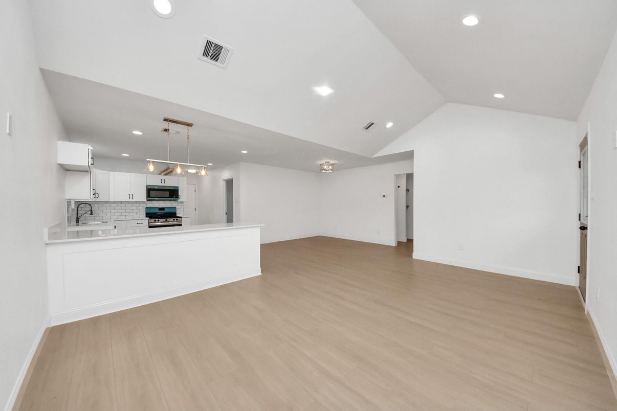 Empty room, Interior, Kitchen, Pendant Lights, Recessed Lighting, Stainless Steel Appliances, Wood Texture Flooring