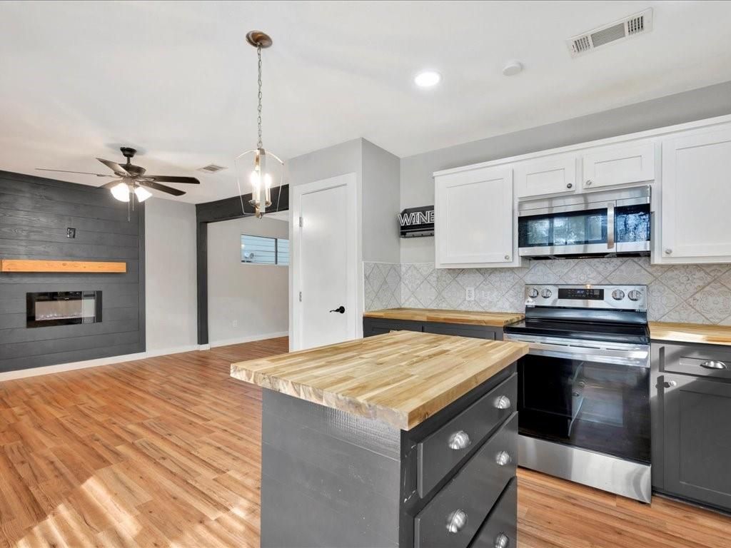 Fireplace, Interior, Kitchen, Pendant Lights, Recessed Lighting, Stainless Steel Appliances, Wood Texture Flooring