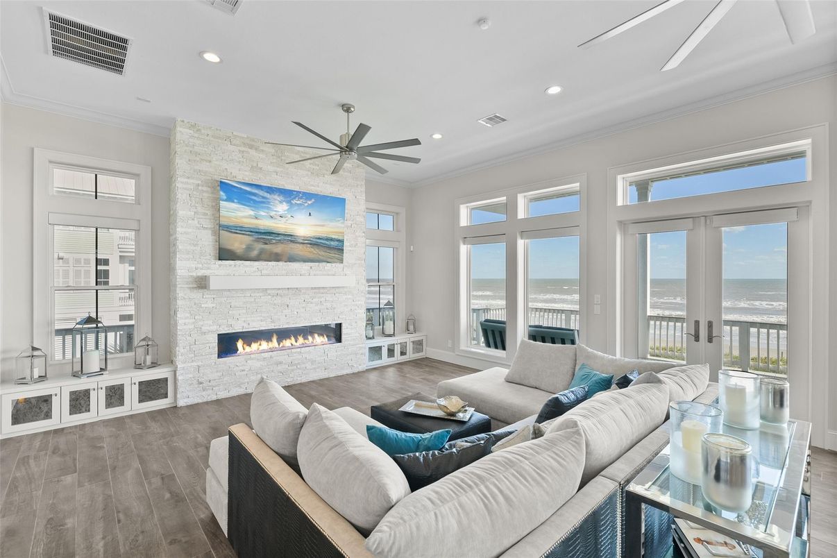 Fireplace, Interior, Living room, Recessed Lighting, Stone Walls, Water, Wood Texture Flooring