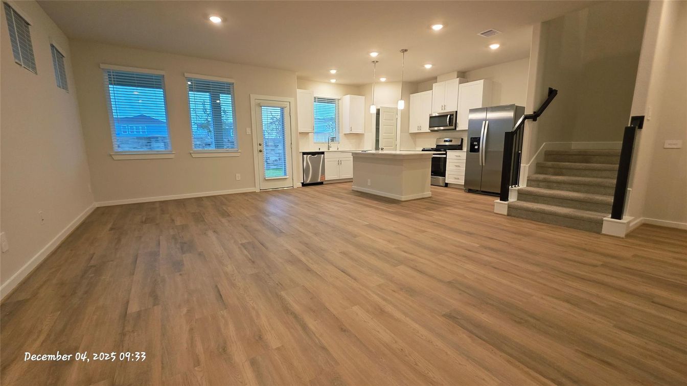 Empty room, Interior, Kitchen, Pendant Lights, Recessed Lighting, Stainless Steel Appliances, Wood Texture Flooring