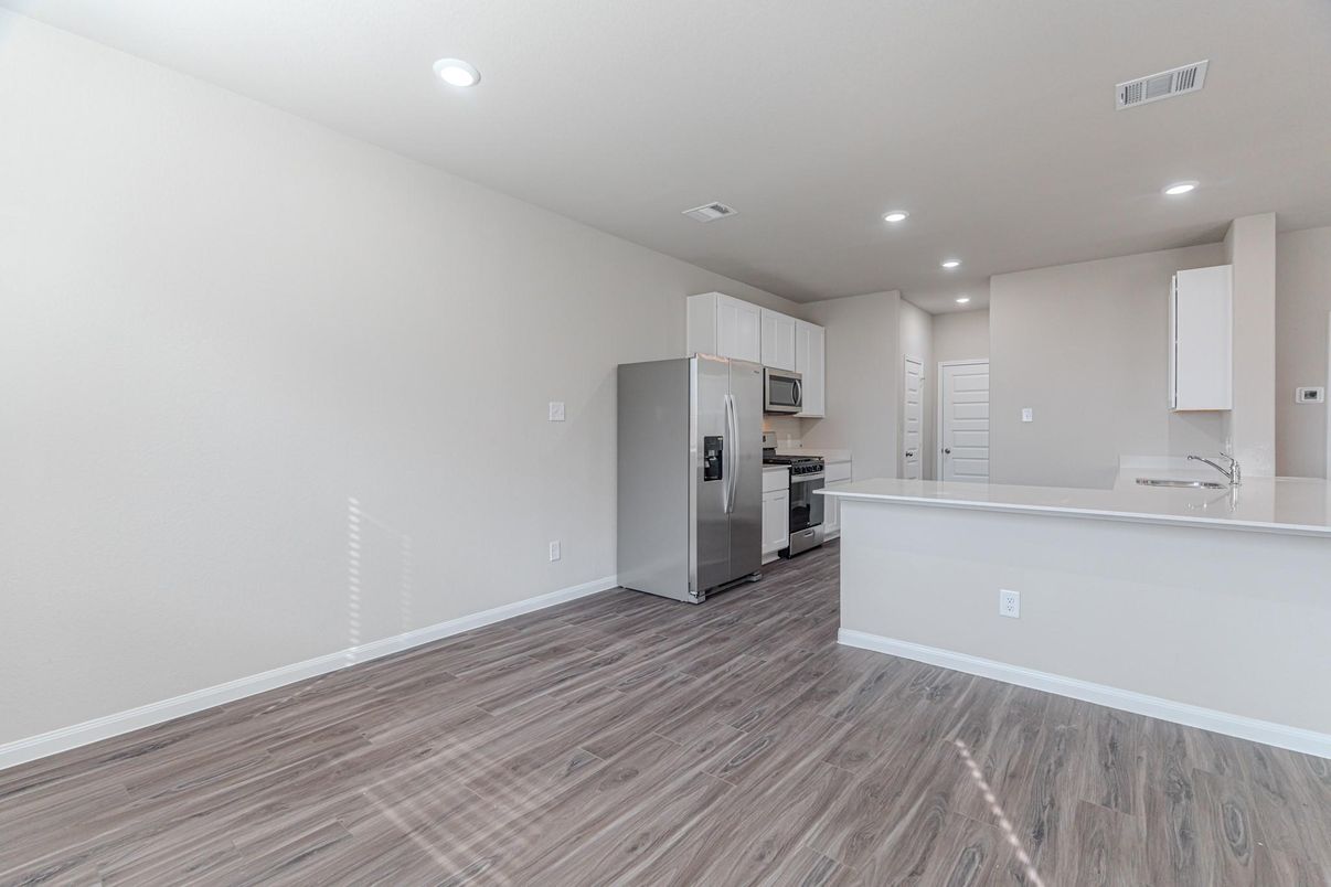 Empty room, Interior, Kitchen, Recessed Lighting, Stainless Steel Appliances, Wood Texture Flooring
