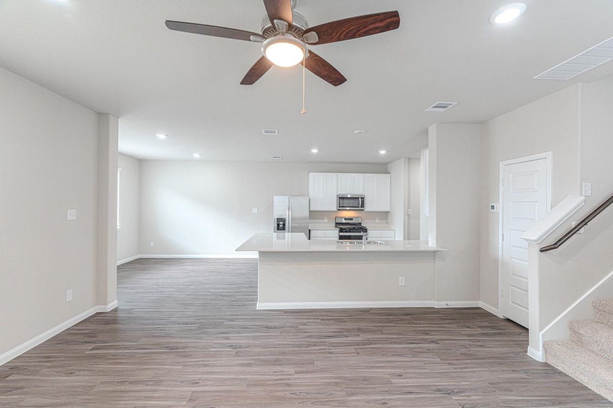 Empty room, Interior, Kitchen, Recessed Lighting, Stainless Steel Appliances, Wood Texture Flooring