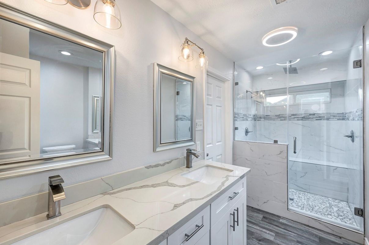 Bathroom, Dual Sink Vanities, Glass Shower, Interior, Marble Walls, Recessed Lighting, Wood Texture Flooring