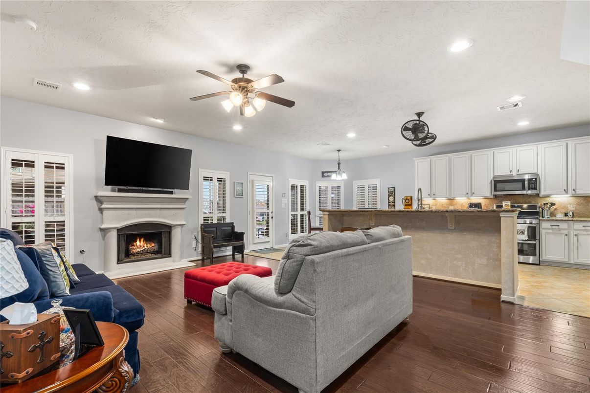 Fireplace, Interior, Kitchen, Living room, Pendant Lights, Recessed Lighting, Stainless Steel Appliances, Wood Texture Flooring