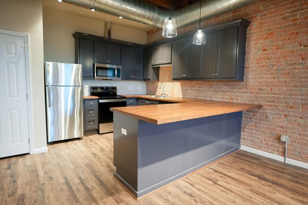 Interior, Kitchen, Pendant Lights, Recessed Lighting, Stainless Steel Appliances, Stone Walls, Wood Texture Flooring