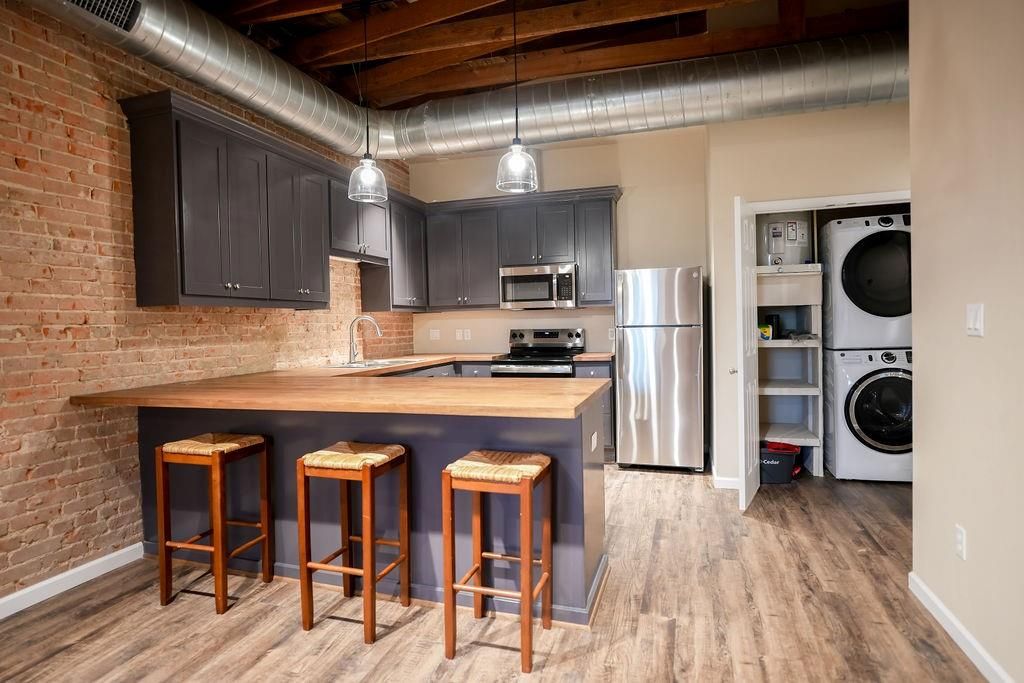 Interior, Kitchen, Pendant Lights, Stainless Steel Appliances, Stone Walls, Washer, Wood Texture Flooring