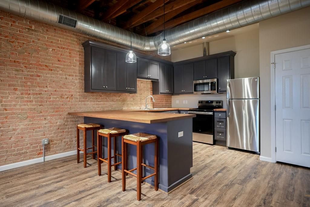 Interior, Kitchen, Pendant Lights, Stainless Steel Appliances, Stone Walls, Wood Texture Flooring
