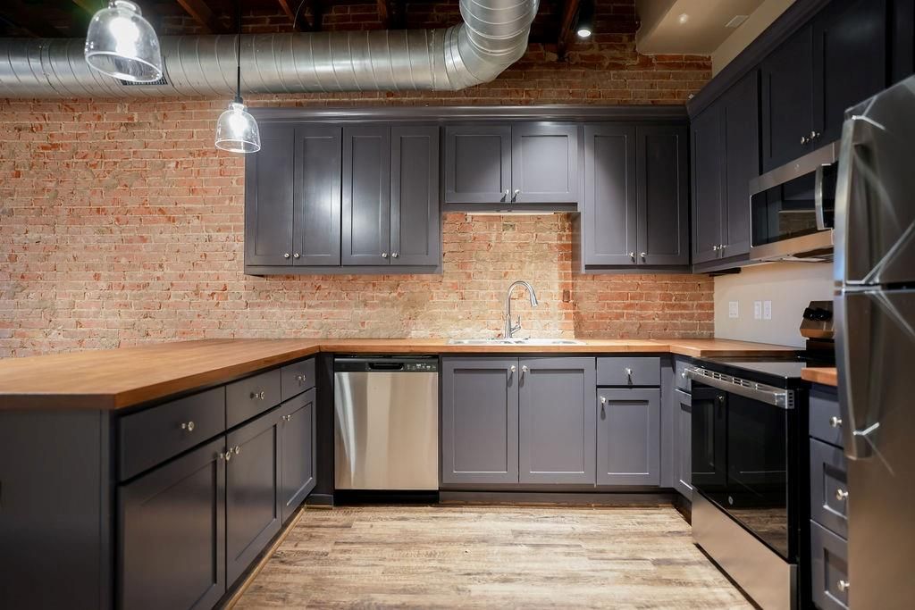 Interior, Kitchen, Pendant Lights, Stainless Steel Appliances, Stone Walls, Wood Texture Flooring