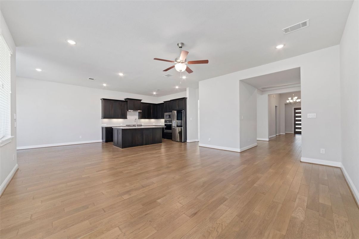 Empty room, Interior, Kitchen, Recessed Lighting, Stainless Steel Appliances, Wood Texture Flooring