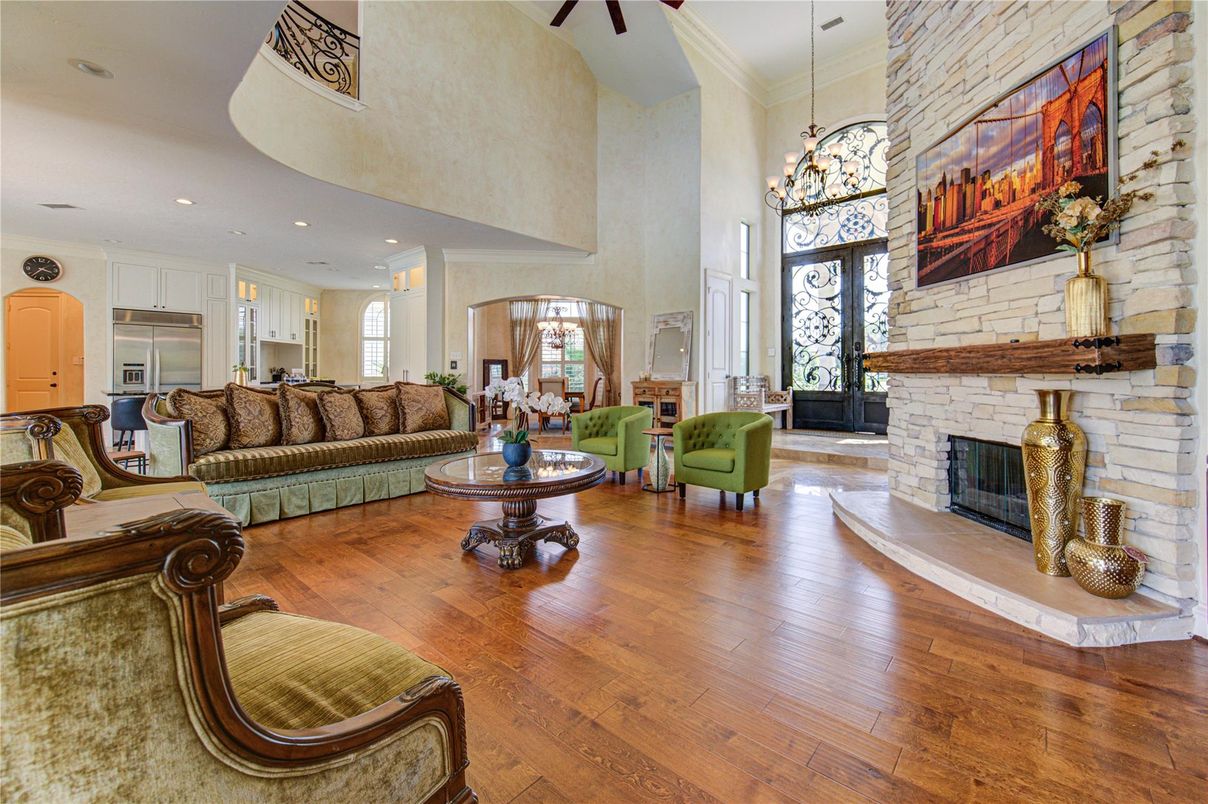 Chandelier, Fireplace, Interior, Kitchen, Living room, Pendant Lights, Recessed Lighting, Stone Walls, Wood Texture Flooring