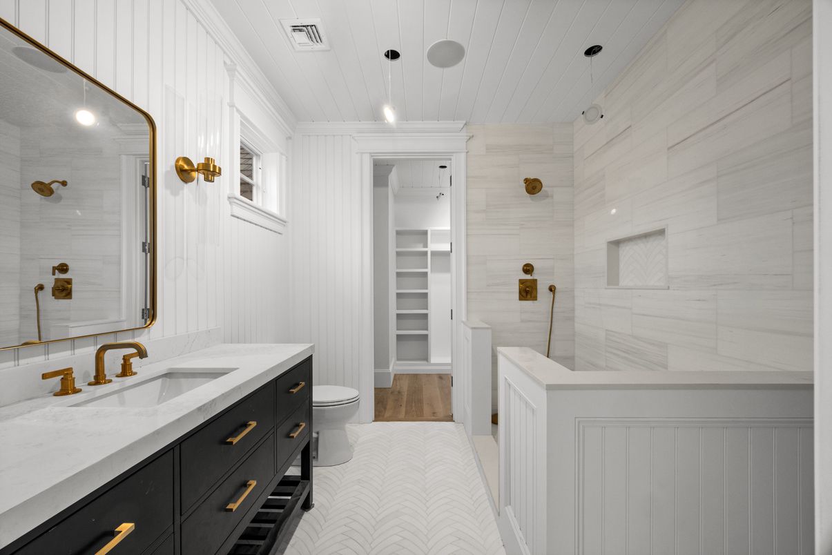 Bathroom, Dual Sink Vanities, Interior, Marble Walls, Pendant Lights, Recessed Lighting, Walk-in Closets, Wood Texture Flooring