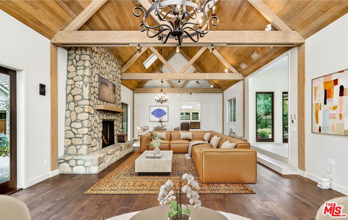 Chandelier, Fireplace, Interior, Living room, Recessed Lighting, Stone Walls, Wooden Beams, Wooden Ceilings, Wood Texture Flooring