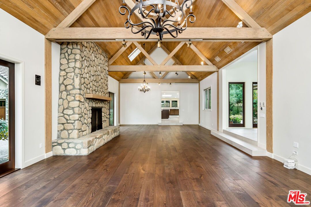 Chandelier, Empty room, Fireplace, Interior, Pendant Lights, Recessed Lighting, Stone Walls, Wooden Beams, Wooden Ceilings, Wood Texture Flooring