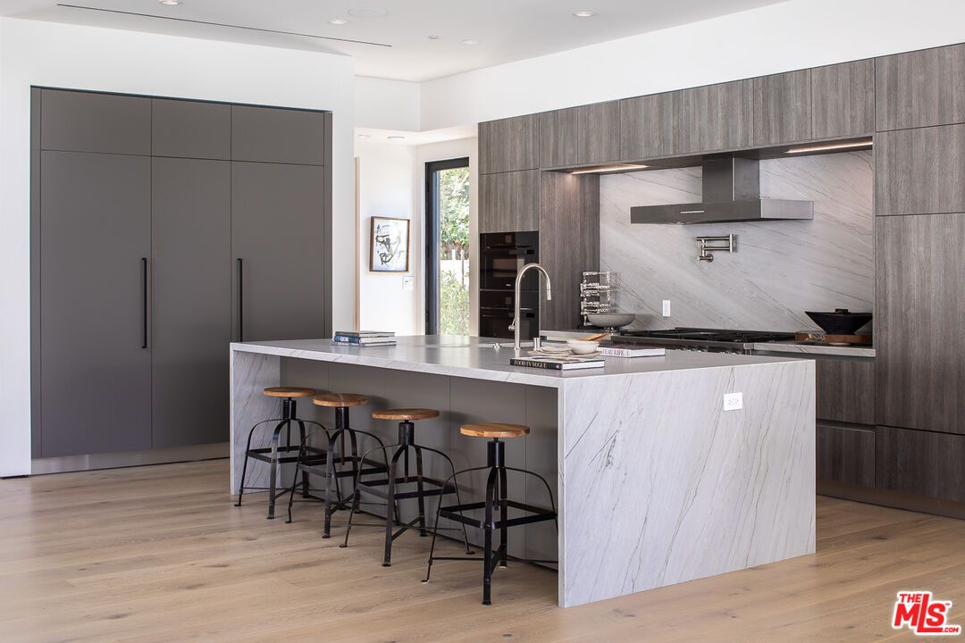 Interior, Kitchen, Marble Walls, Recessed Lighting, Stainless Steel Appliances, Wood Texture Flooring