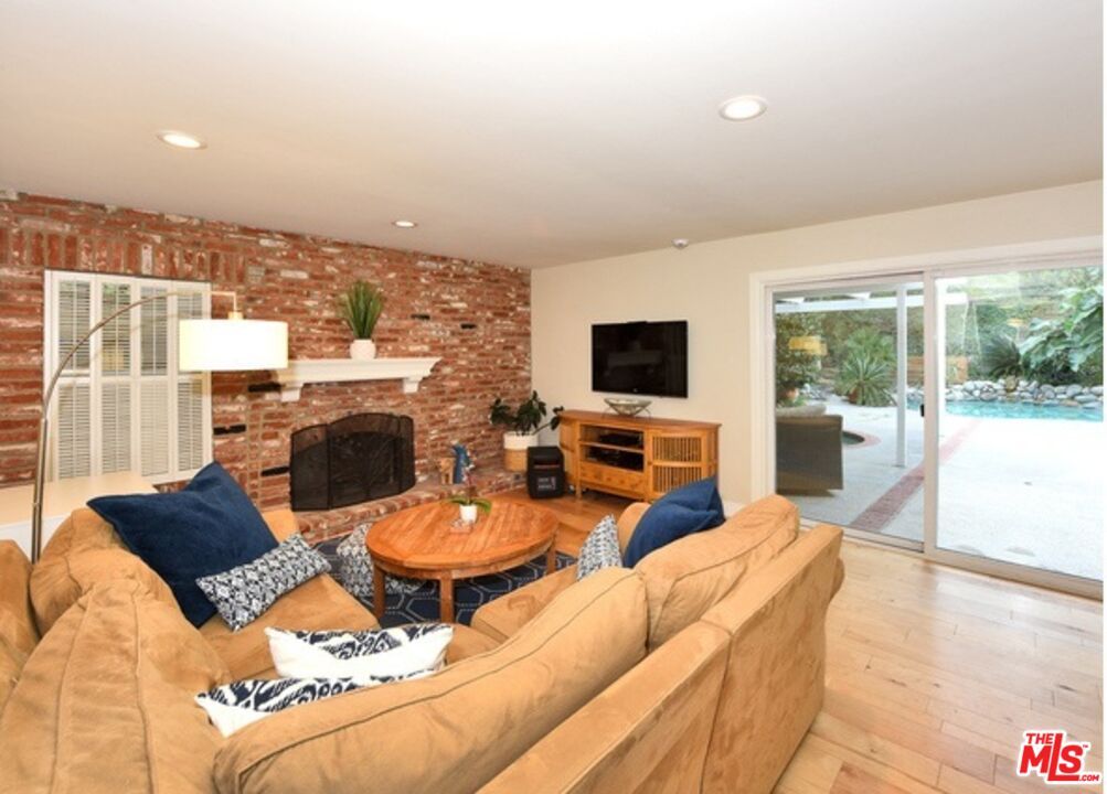 Fireplace, Interior, Living room, Recessed Lighting, Stone Walls, Wood Texture Flooring