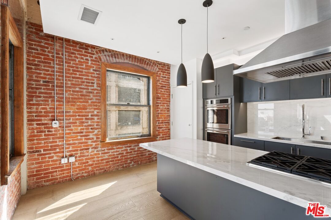 Interior, Kitchen, Pendant Lights, Recessed Lighting, Stainless Steel Appliances, Stone Walls, Wood Texture Flooring