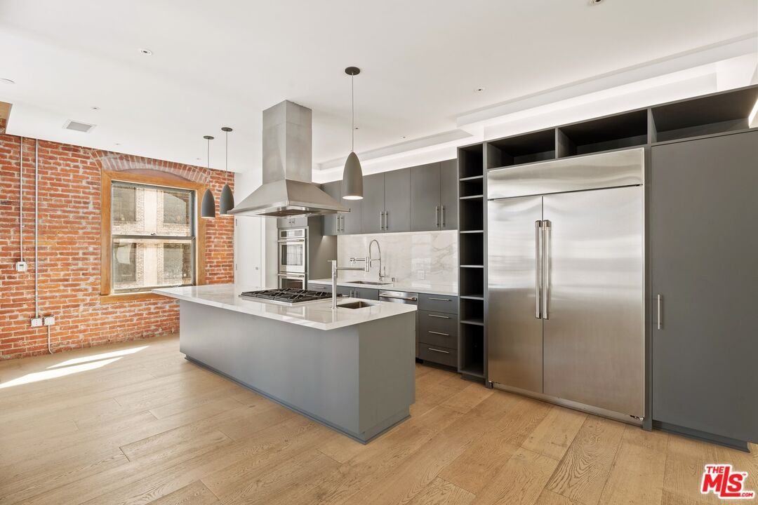 Interior, Kitchen, Pendant Lights, Recessed Lighting, Stainless Steel Appliances, Stone Walls, Wood Texture Flooring