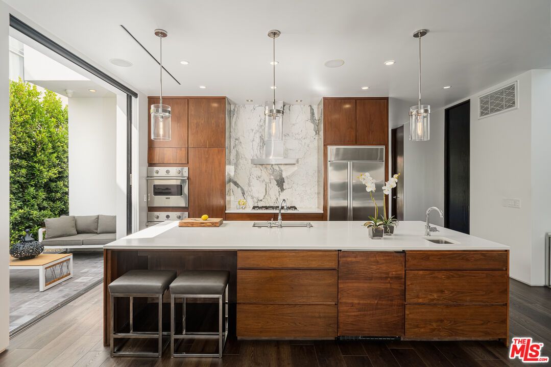 Interior, Kitchen, Marble Walls, Pendant Lights, Recessed Lighting, Stainless Steel Appliances, Wood Texture Flooring